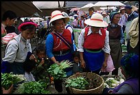 Bai women buying vegetables at the Monday market. Shaping, Yunnan, China
