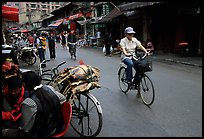Woman on bicycle in an old backstreet. Kunming, Yunnan, China