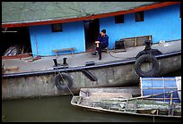 Man sitting on a house boat. Leshan, Sichuan, China ( color)