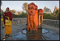Holy man next to Shiva image. Khajuraho, Madhya Pradesh, India