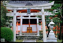 Tori gate at the entrance of a shrine inner grounds. The act of passing through purifies the soul.. Kyoto, Japan ( color)