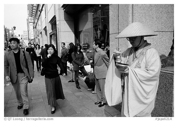 Buddhist monk seeking alms in front of a Ginza department store. Tokyo, Japan
