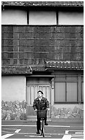 Bicyclist in front of a traditional style house. Kyoto, Japan (black and white)