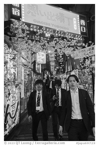 Men in suits at Omoide Yokocho at night, Shinjuku. Tokyo, Japan (black and white)