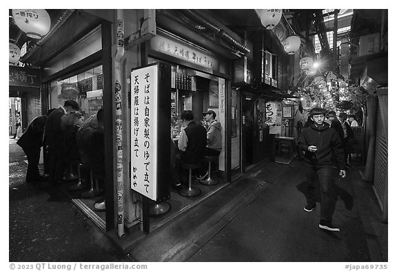 Food stall in narrow alley, Omoide Yokocho, Shinjuku. Tokyo, Japan (black and white)