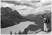Hiker wearing backpack looking at Peyto Lake. Banff National Park, Canadian Rockies, Alberta, Canada ( black and white)