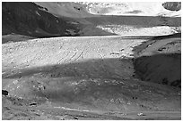Base of Athabasca Glacier with cars parked on lot. Jasper National Park, Canadian Rockies, Alberta, Canada (black and white)