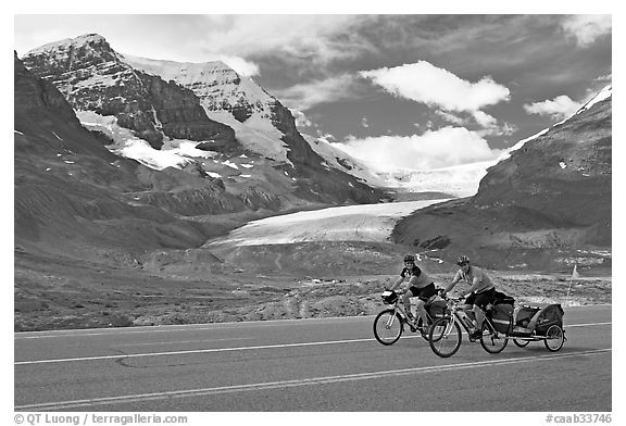 Cyclists on the Icefields Parkway in front of the Athabasca Glacier. Jasper National Park, Canadian Rockies, Alberta, Canada