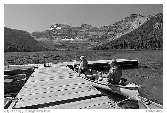 Canoists parking to dock, Cameron Lake. Waterton Lakes National Park, Alberta, Canada (black and white)