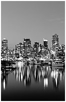 Fishing boats and skyline light reflected at night. Vancouver, British Columbia, Canada ( black and white)