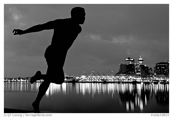 Harry Jerome (a former great sprinter)  statue and Harbor at night. Vancouver, British Columbia, Canada (black and white)