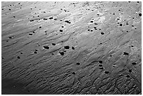 Pebbles and wet sand at sunset, Half-moon bay. Pacific Rim National Park, Vancouver Island, British Columbia, Canada (black and white)