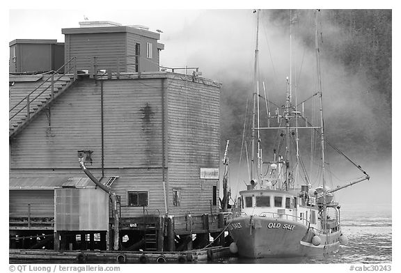 Commercial fishing boat next to a fishery, Tofino. Vancouver Island, British Columbia, Canada (black and white)