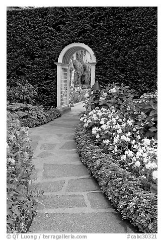 Arched entrance  leading to the Italian Garden. Butchart Gardens, Victoria, British Columbia, Canada (black and white)