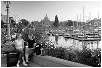 Young Women sitting, Inner harbor. Victoria, British Columbia, Canada (black and white)