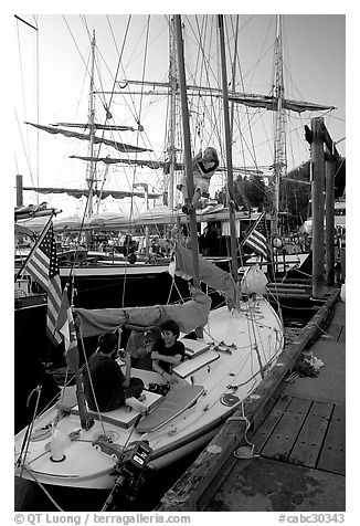 Kids in a small sailboat docked in Inner Habor. Victoria, British Columbia, Canada (black and white)