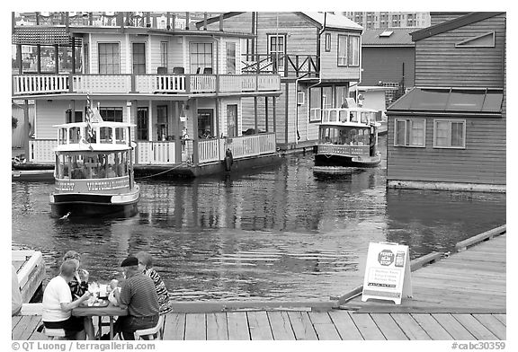 Harbor ferries and outdoor eatery, Upper Harbor. Victoria, British Columbia, Canada (black and white)