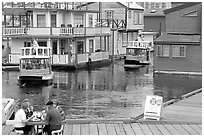 Harbor ferries and outdoor eatery, Upper Harbor. Victoria, British Columbia, Canada (black and white)