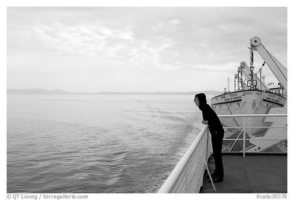 Woman looking out from deck of ferry. Vancouver Island, British Columbia, Canada