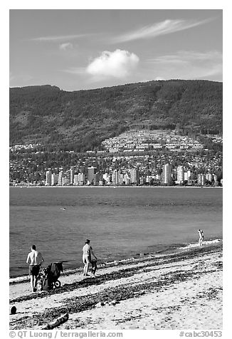 Family near the water on a beach, Stanley Park. Vancouver, British Columbia, Canada (black and white)