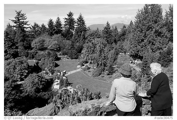 Elderly couple looking at the Sunken Garden in Queen Elizabeth Park. Vancouver, British Columbia, Canada (black and white)