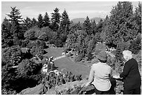 Elderly couple looking at the Sunken Garden in Queen Elizabeth Park. Vancouver, British Columbia, Canada (black and white)