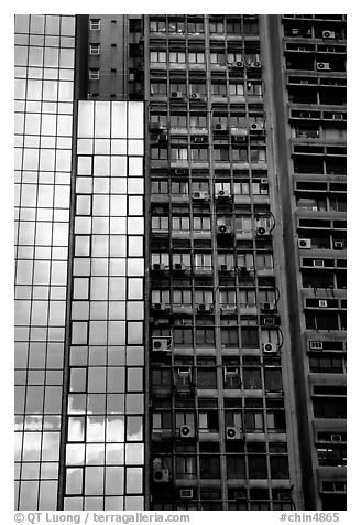 Modern building next to old  building with air conditioners, Hong-Kong Island. Hong-Kong, China (black and white)