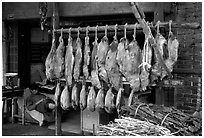 Ham made with cattle legs, salted when raw, and dried under the sun. Kunming, Yunnan, China (black and white)