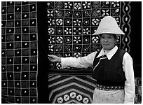 Woman in Bai dress showing drapes of traditional design. Dali, Yunnan, China (black and white)