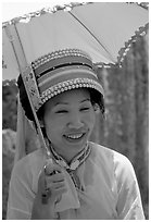 Woman from the Sani branch of the Yi tribespeople with a sun unbrella. Shilin, Yunnan, China (black and white)