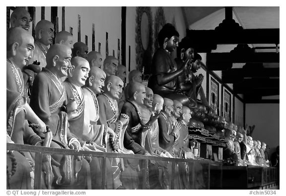 Some of the 1000 individually unique Terracotta arhat monks in Luohan Hall. Leshan, Sichuan, China (black and white)