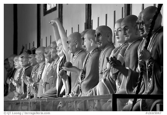 Incredible arrays of postures and expressions of some of the 1000 Terracotta arhat monks in Luohan Hall. Leshan, Sichuan, China (black and white)