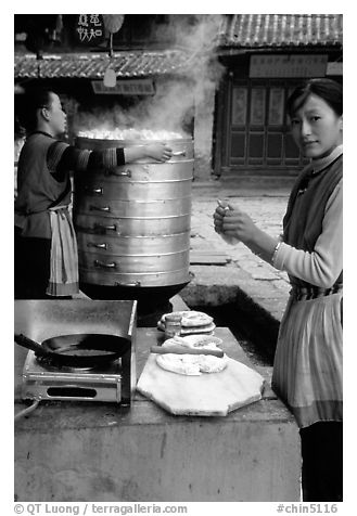Naxi Woman preparing the baba flatbreat. Lijiang, Yunnan, China (black and white)