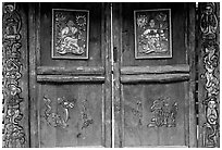 Decorated doors of a temple. Lijiang, Yunnan, China ( black and white)