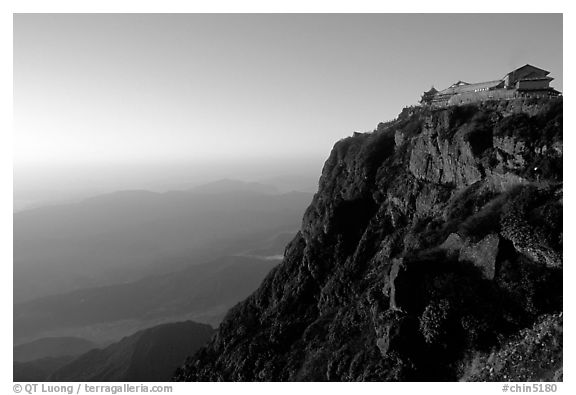 Jinding Si temple perched on a precipituous cliff at sunrise. Emei Shan, Sichuan, China (black and white)