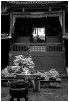 Buddha image seen from rainy courtyard of Hongchunping temple. Emei Shan, Sichuan, China (black and white)