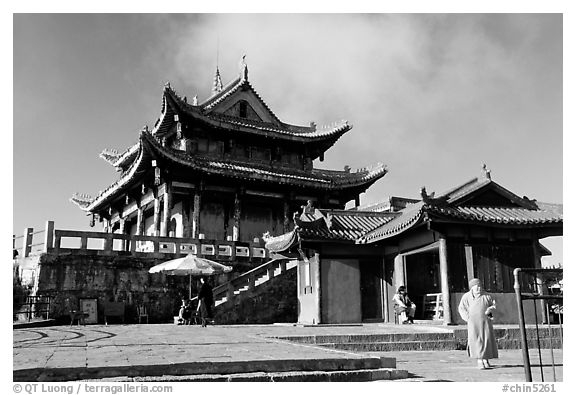 Monk walking in front of Jinding Si temple. Emei Shan, Sichuan, China (black and white)