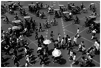 Pedestrians and bicyclists cross a major avenue. Chengdu, Sichuan, China ( black and white)