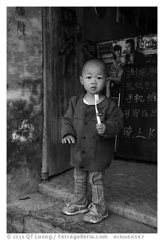 Boy with toothbrush. Xidi Village, Anhui, China (black and white)