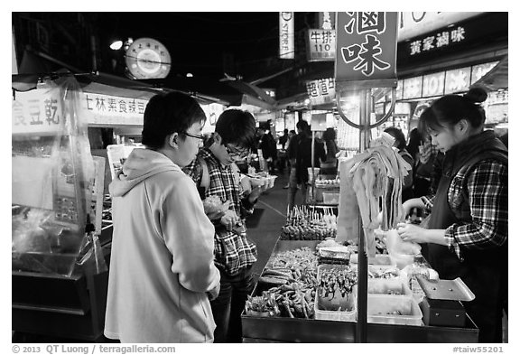 Customer buying foods at Shilin Night Market. Taipei, Taiwan