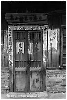 Door with weathered wood and inscriptions. Lukang, Taiwan (black and white)
