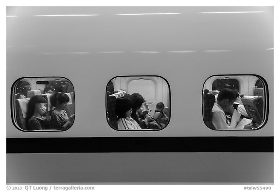 High speed rail car passengers seen through windows. Taiwan