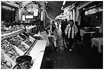 Rue des Bouchers, a narrow cobbled street lined with restaurants. Brussels, Belgium ( black and white)