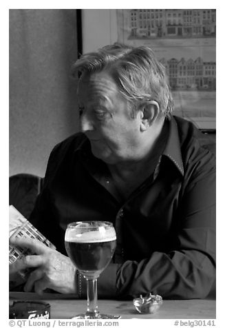 Man with book and beer. Brussels, Belgium (black and white)