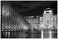 Pyramid, basin, and Louvre at night. Paris, France ( black and white)