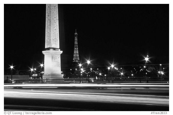Car lights,  obelisk, and Eiffel Tower at night. Paris, France (black and white)