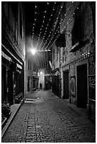 Medieval street by night with Christmas decorations and. Carcassonne, France (black and white)