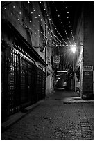Lonely street by night with Tabac sign and Christmas lights. Carcassonne, France ( black and white)