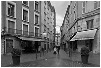 Pedestrian street with couple pushing stroller. Grenoble, France (black and white)