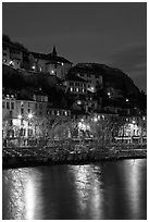 Hillside houses and Christmas lights reflected in Isere River. Grenoble, France (black and white)